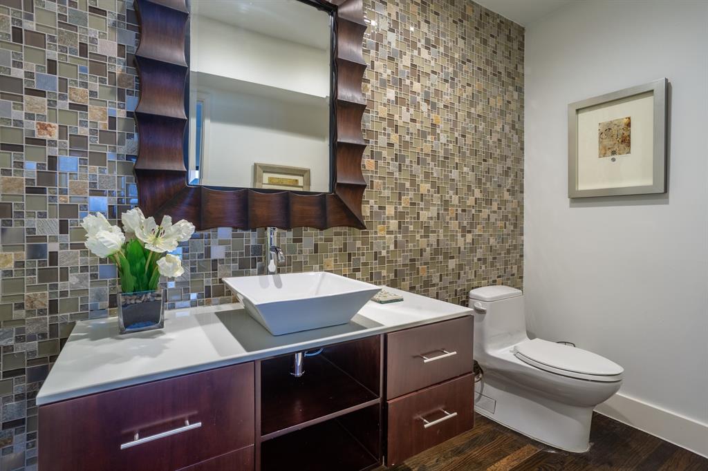 2630 Welborn Street Dallas, TX 75219 - Photo 13 of 40 a bathroom with a sink a toilet and mirror