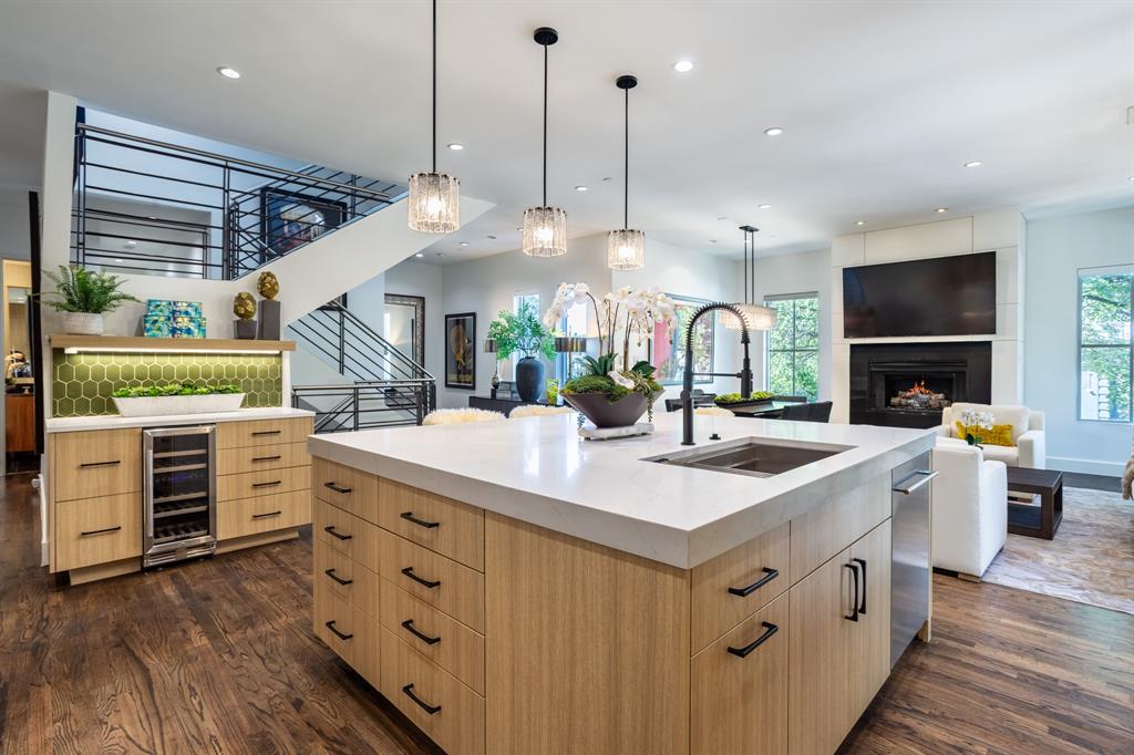 2630 Welborn Street Dallas, TX 75219 - Photo 20 of 40 a kitchen with stainless steel appliances kitchen island granite countertop a sink a counter space and wooden floors