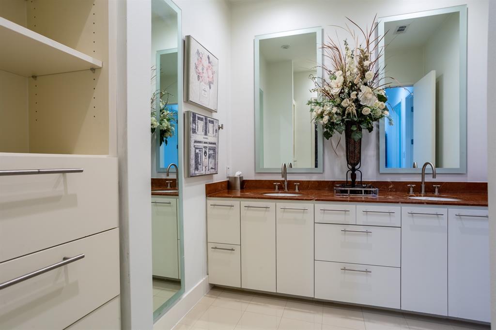 2630 Welborn Street Dallas, TX 75219 - Photo 23 of 40 a bathroom with double vanity and a mirror