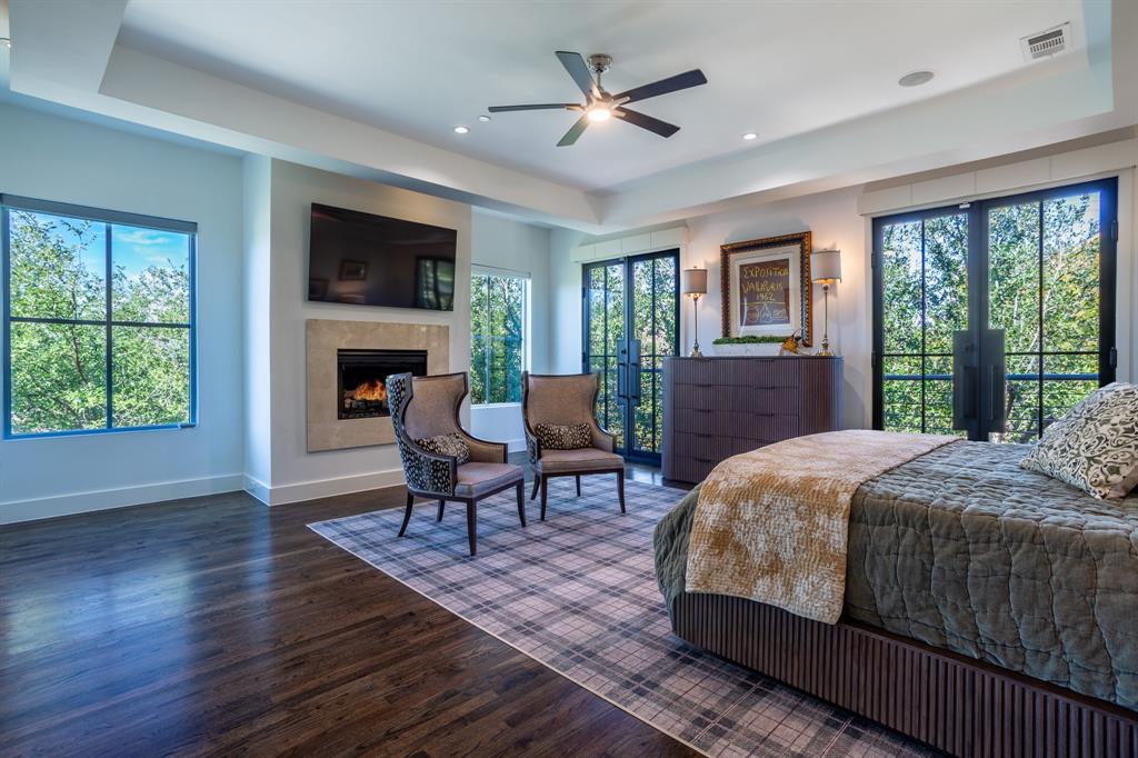 2630 Welborn Street Dallas, TX 75219 - Photo 26 of 40 a bedroom with a bed and a fireplace