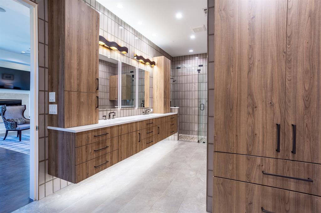 2630 Welborn Street Dallas, TX 75219 - Photo 27 of 40 a bathroom with a double vanity sink and a mirror