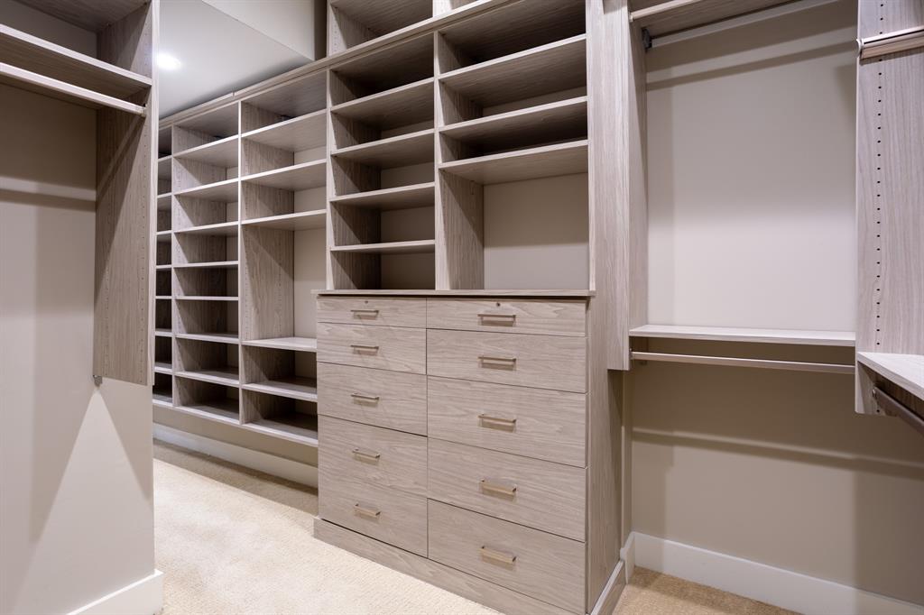 2630 Welborn Street Dallas, TX 75219 - Photo 30 of 40 a view of walk in closet with empty racks