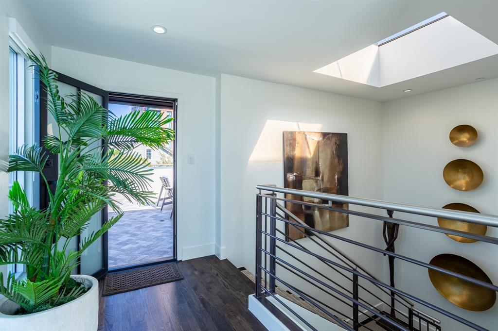 2630 Welborn Street Dallas, TX 75219 - Photo 34 of 40 a view of a hallway with furniture and a potted plant
