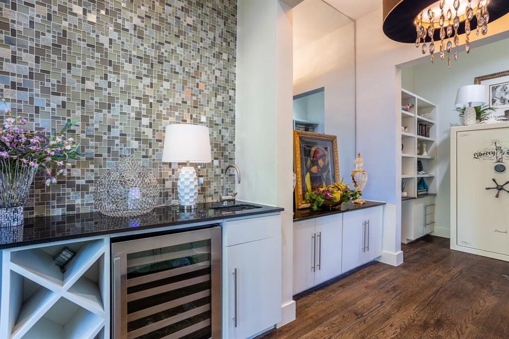 2630 Welborn Street Dallas, TX 75219 - Photo 10 of 40 a hallway with a sink and a mirror