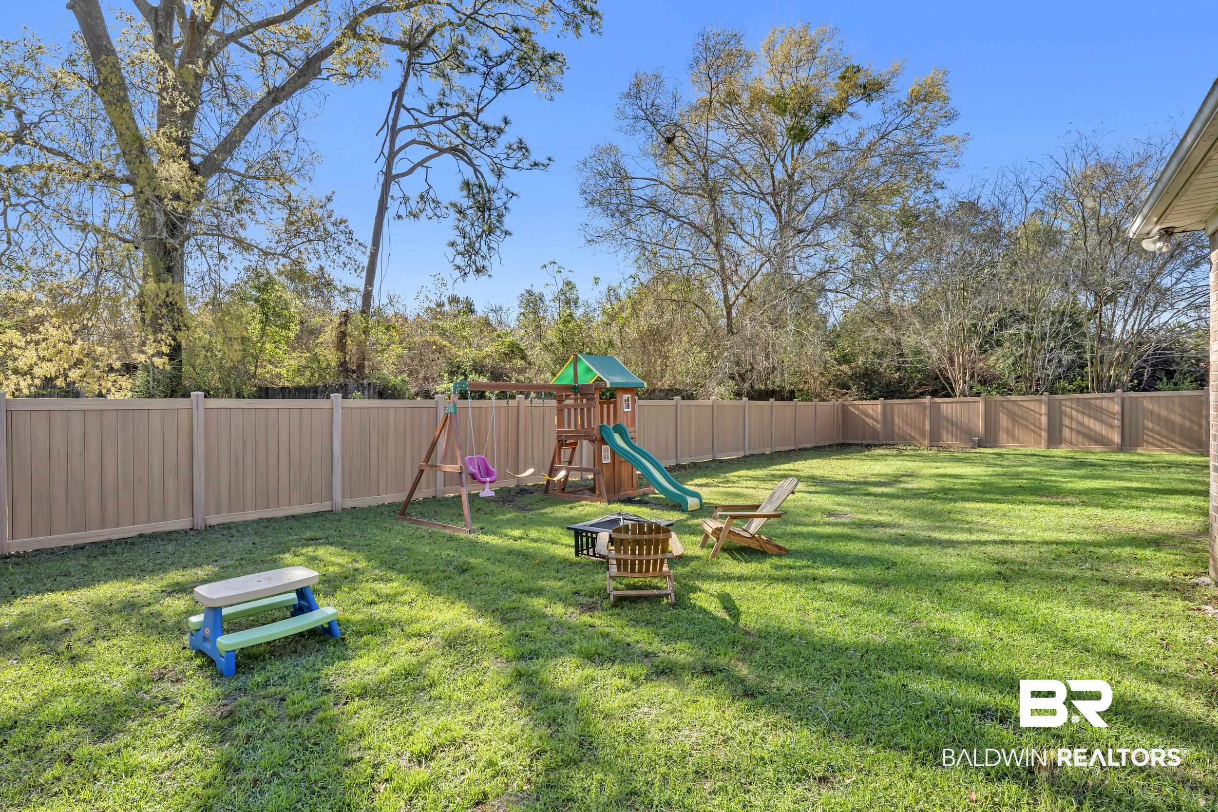 31527 Heidelbrook Loop Daphne, AL 36527 - Photo 3 of 22 Fenced backyard with a playground