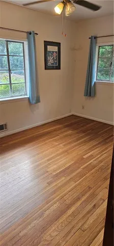 a view of a room with wooden floor and window