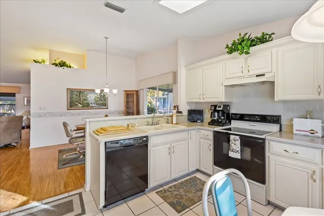 a kitchen with a sink appliances and cabinets