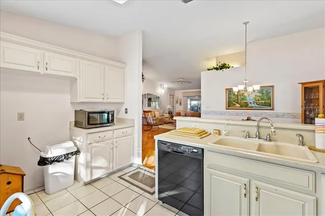 a living room with furniture kitchen view and a window