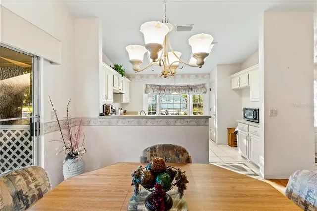 a kitchen with a stove a table and chairs in it