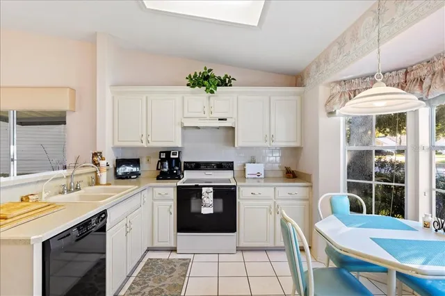 a kitchen with a sink appliances and cabinets