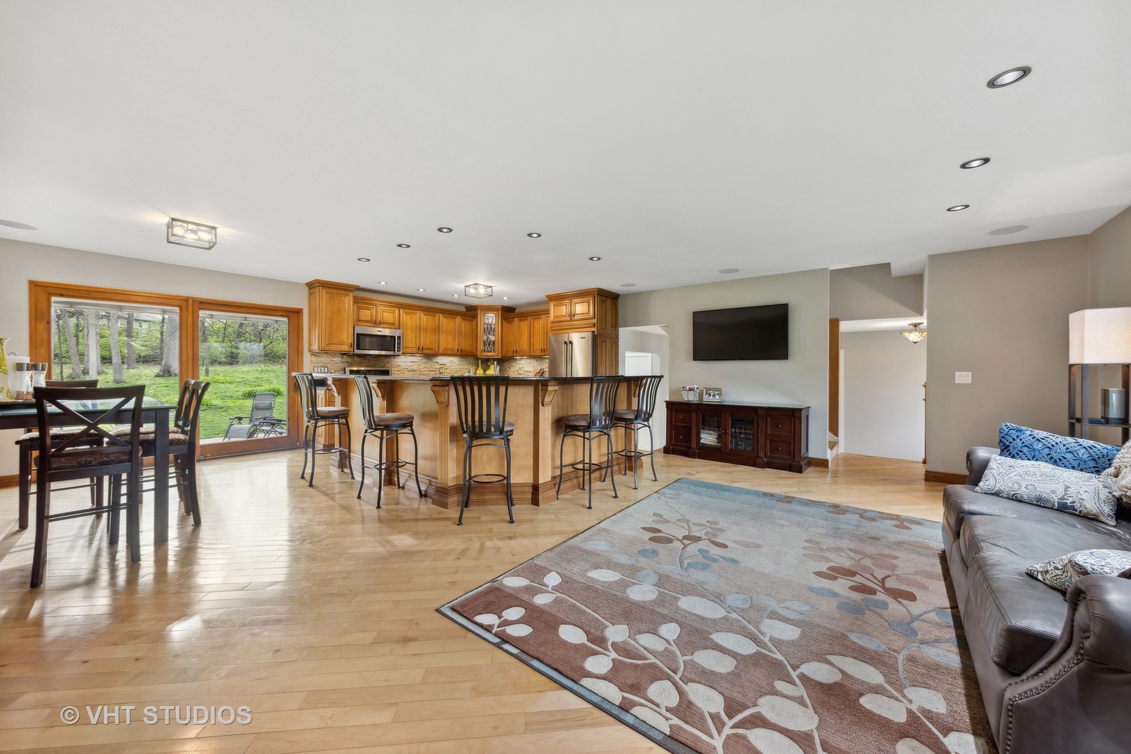 8521 Una Avenue Naperville, IL 60565 - Photo 11 of 41 a living room with furniture a fireplace and a flat screen tv