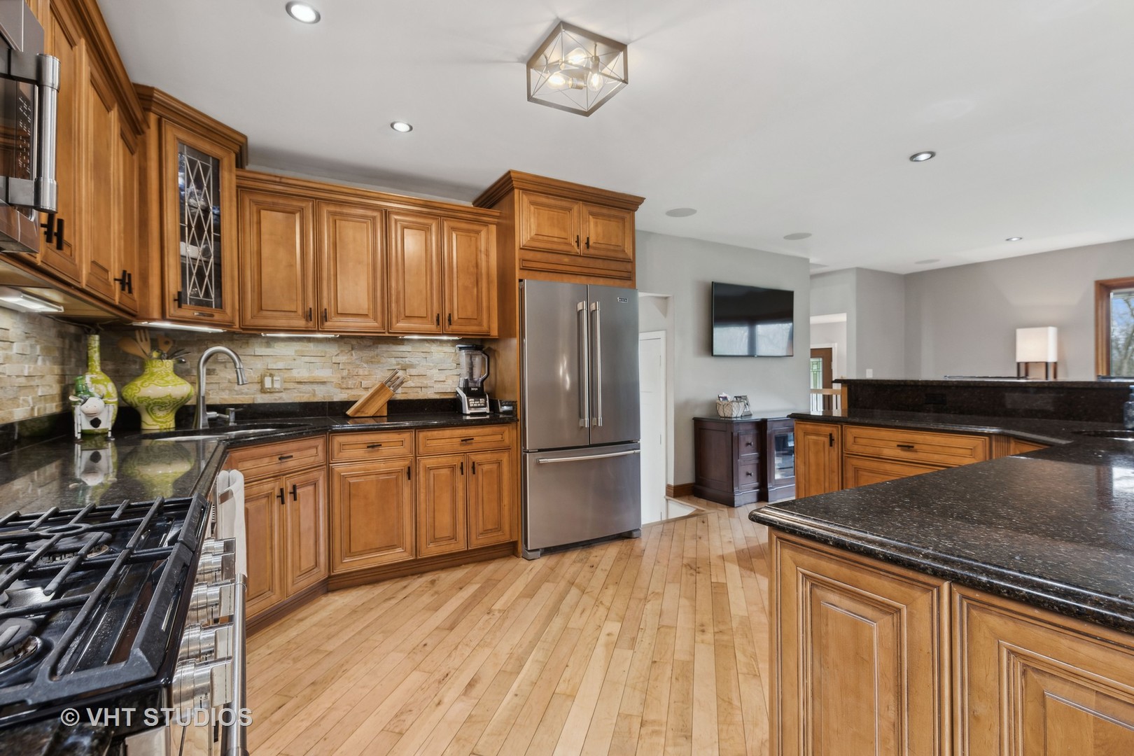 8521 Una Avenue Naperville, IL 60565 - Photo 13 of 41 a kitchen with granite countertop stainless steel appliances a stove top oven a sink a counter space and cabinets