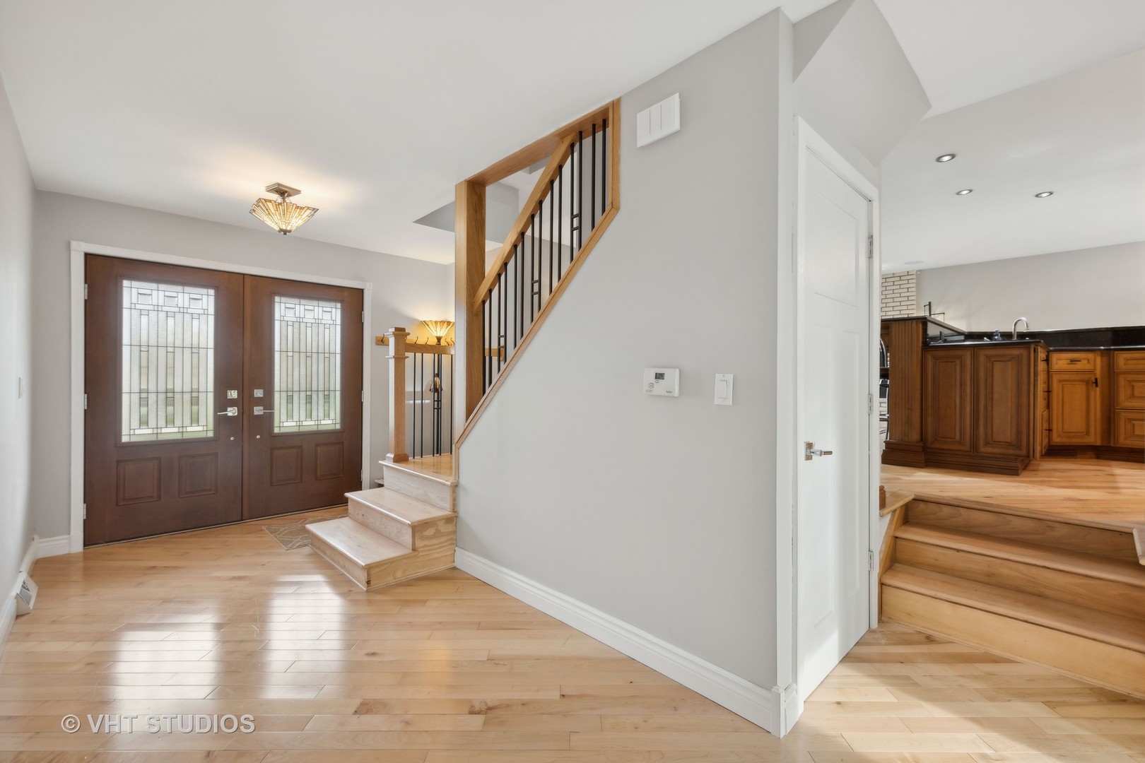 8521 Una Avenue Naperville, IL 60565 - Photo 7 of 41 a view of an entryway with wooden floor and door