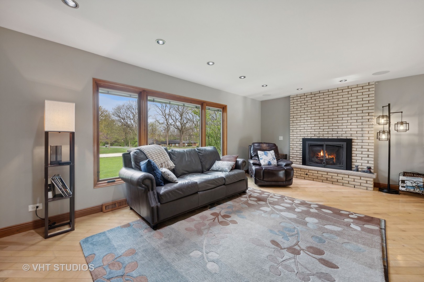 8521 Una Avenue Naperville, IL 60565 - Photo 9 of 41 a living room with furniture large window and a fireplace