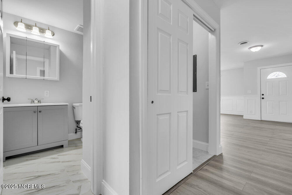 29 Carlisle Road Toms River, NJ 08757 - Photo 15 of 23 a view of a bathroom with closet and wooden floor