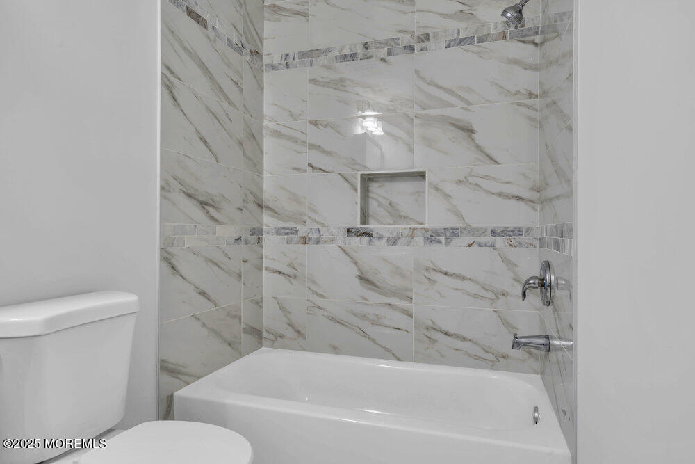29 Carlisle Road Toms River, NJ 08757 - Photo 17 of 23 a bathroom with a toilet and a bathtub