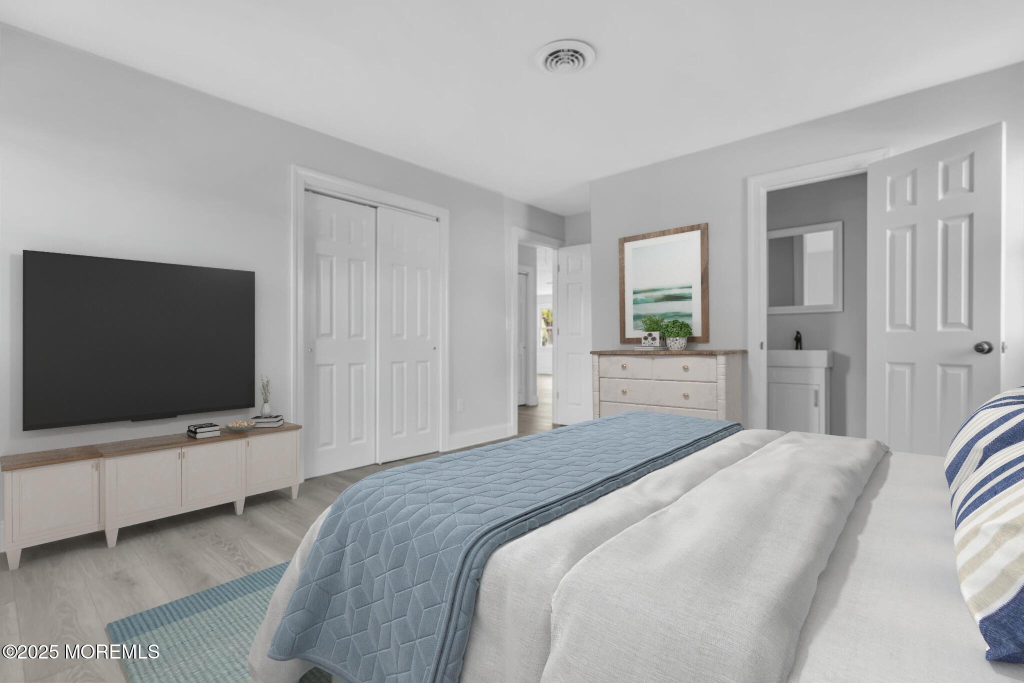 29 Carlisle Road Toms River, NJ 08757 - Photo 6 of 23 a bedroom with a bed and a flat tv screen on wall