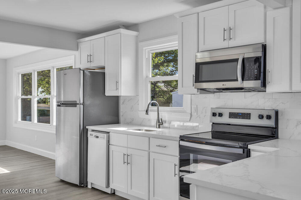 29 Carlisle Road Toms River, NJ 08757 - Photo 8 of 23 a kitchen with kitchen island a sink stainless steel appliances and cabinets