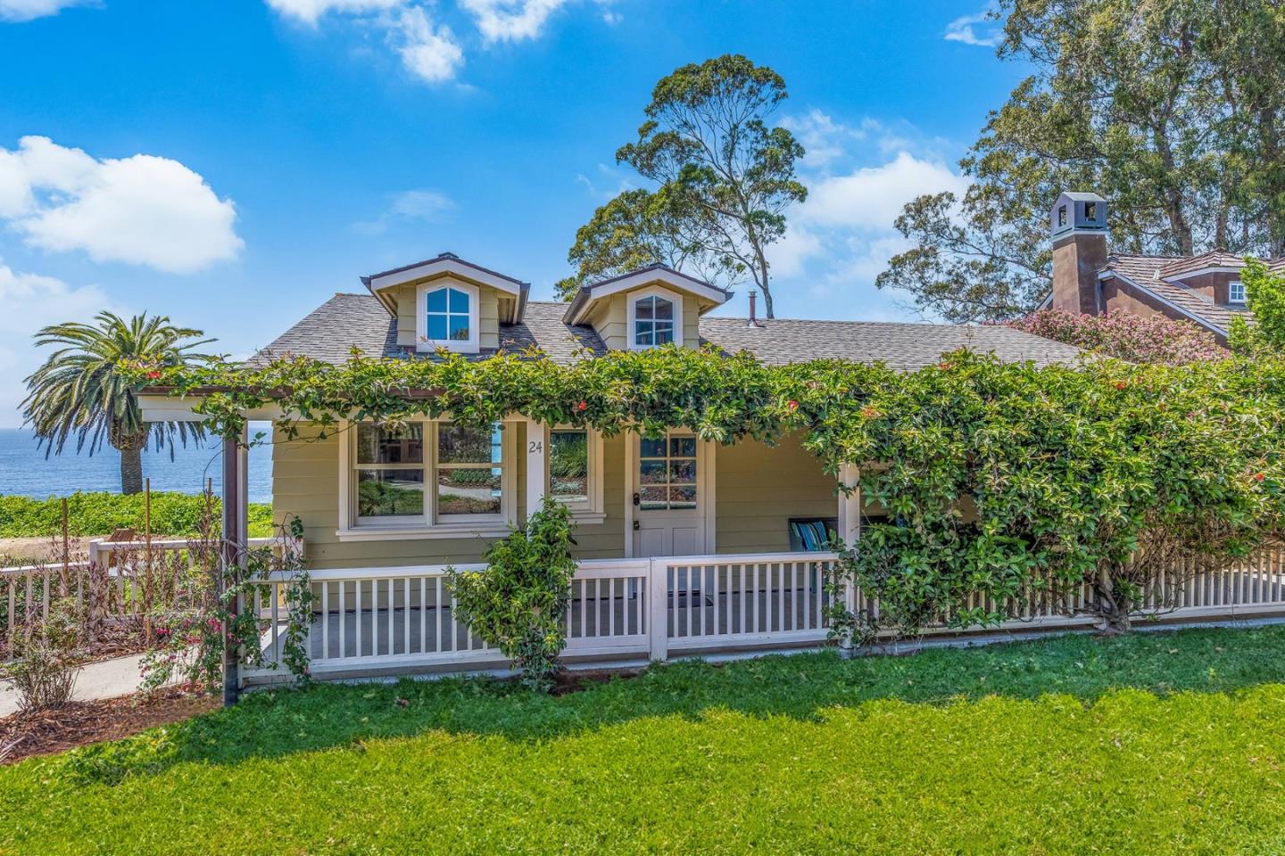 a front view of a house with a garden