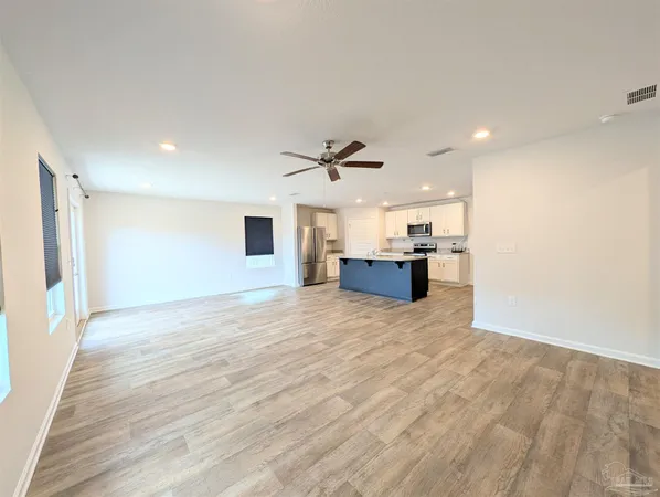 a view of kitchen and kitchen with microwave