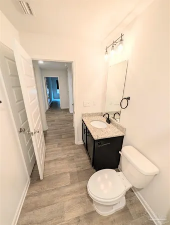 a bathroom with a toilet a sink and mirror