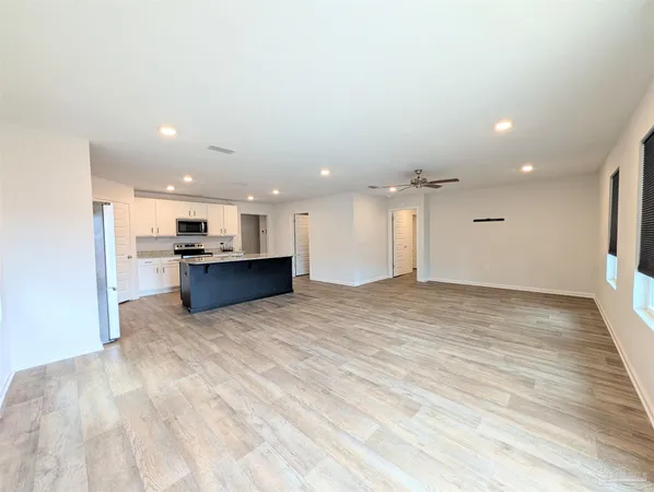 a view of kitchen with kitchen island and stainless steel appliances