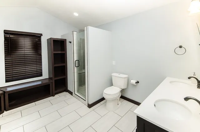 a bathroom with a sink toilet and shower