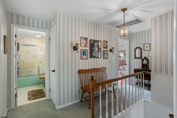 a view of a hallway with workspace and entryway