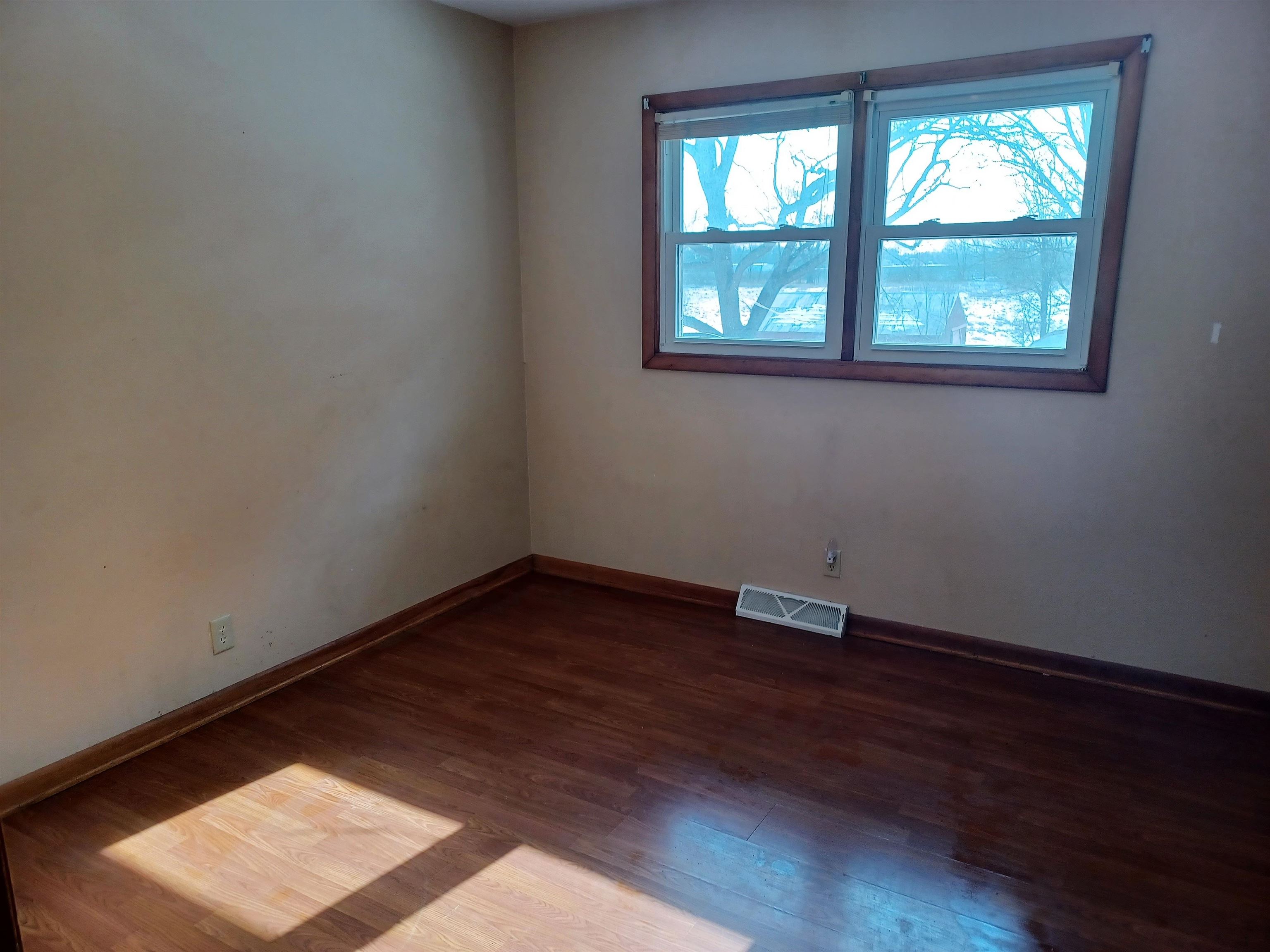 5162 Simpson Road Rockford, IL 61102 - Photo 13 of 14 an empty room with wooden floor and windows