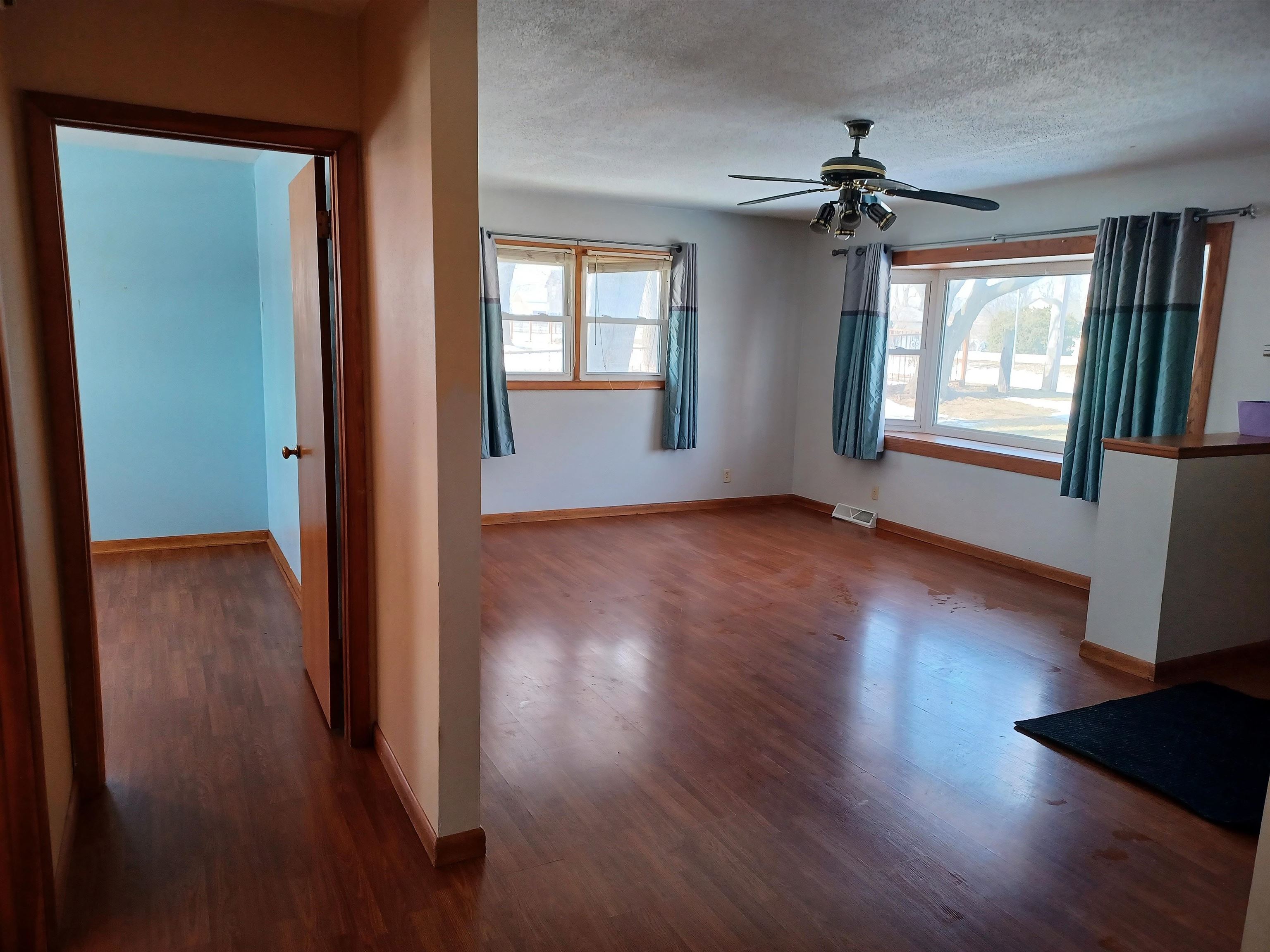 5162 Simpson Road Rockford, IL 61102 - Photo 3 of 14 wooden floor in an empty room with a window