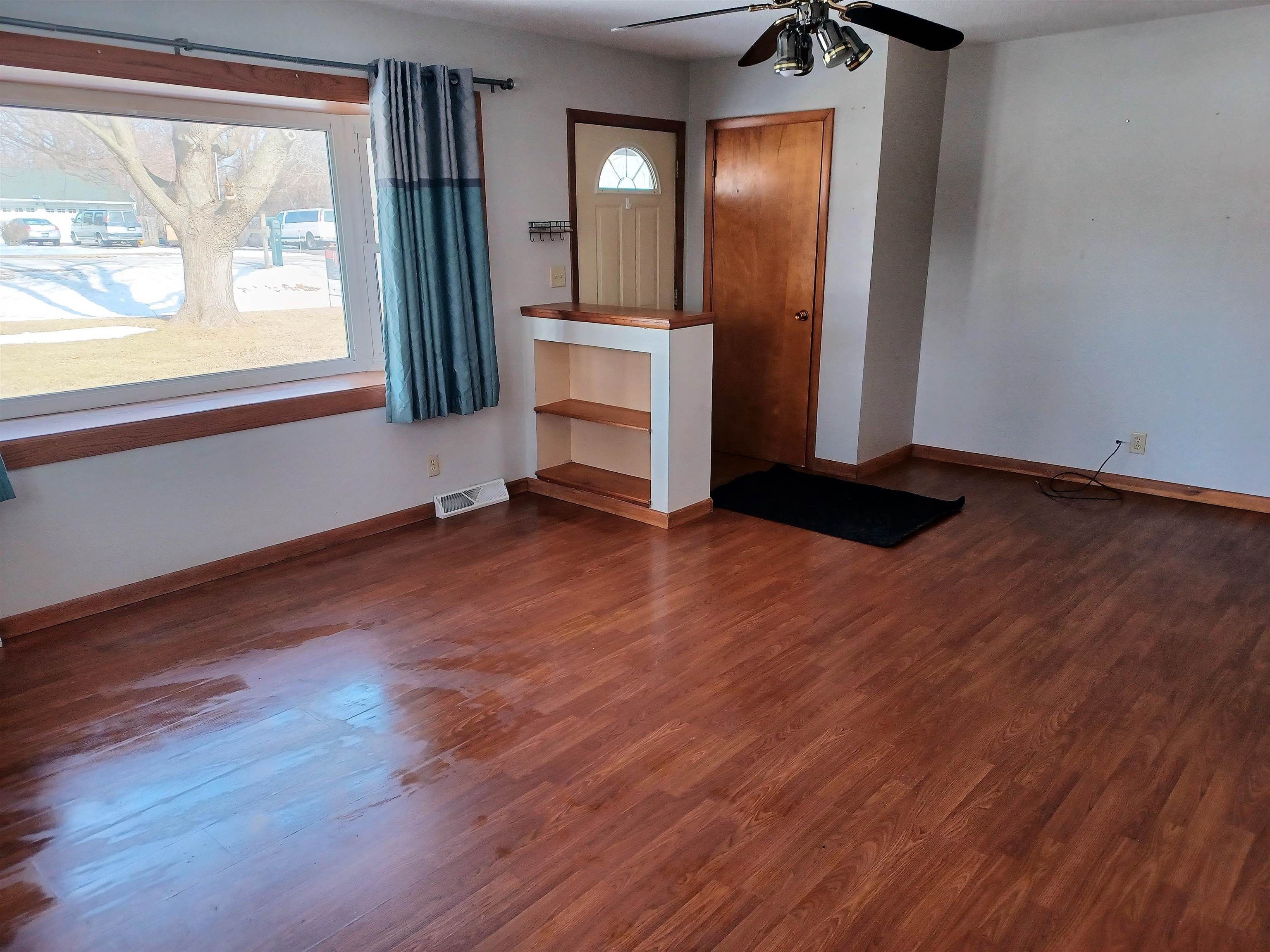 5162 Simpson Road Rockford, IL 61102 - Photo 4 of 14 an empty room with wooden floor and windows