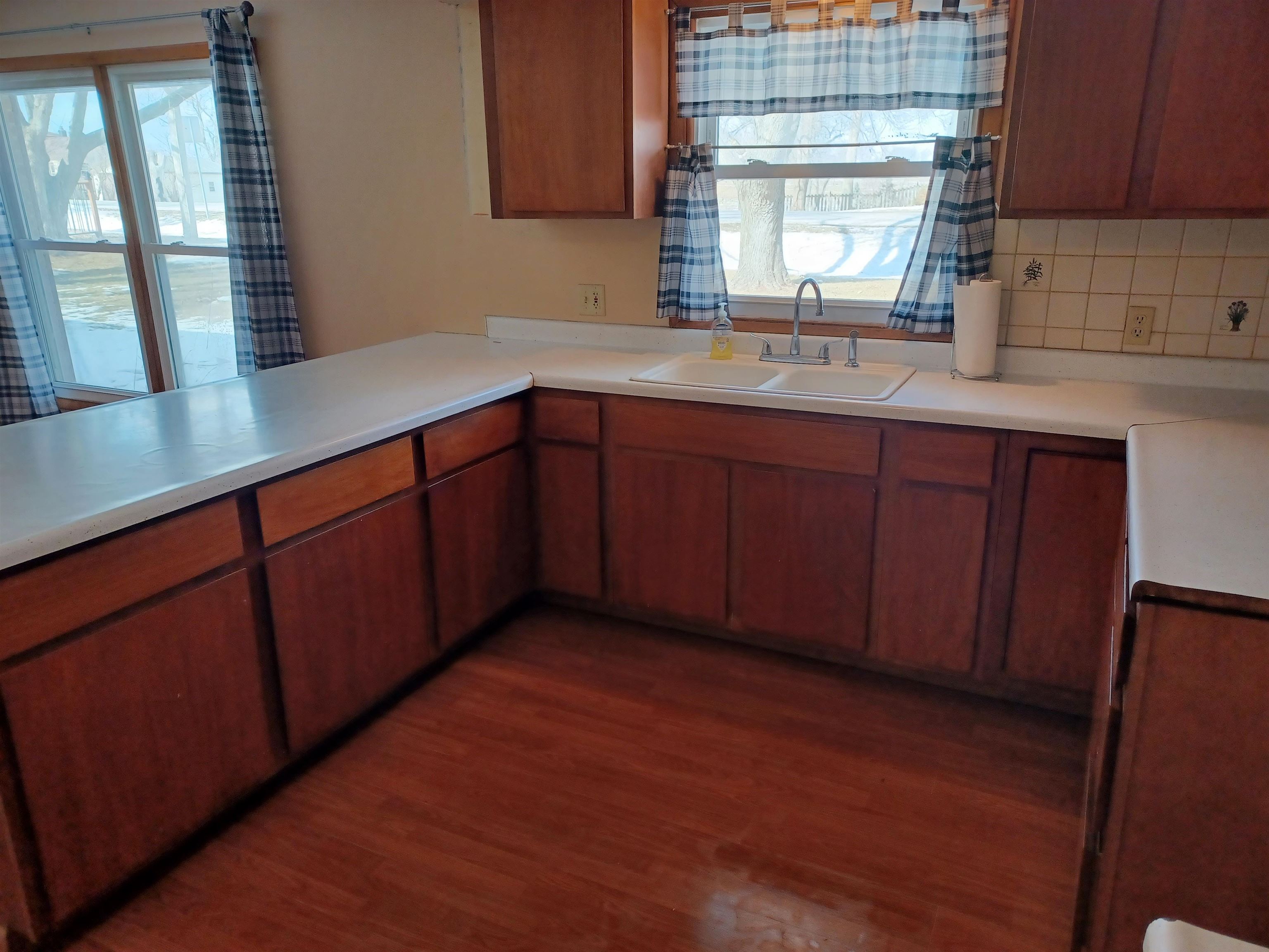 5162 Simpson Road Rockford, IL 61102 - Photo 7 of 14 a kitchen with stainless steel appliances granite countertop wooden cabinets a sink and dishwasher with wooden floor