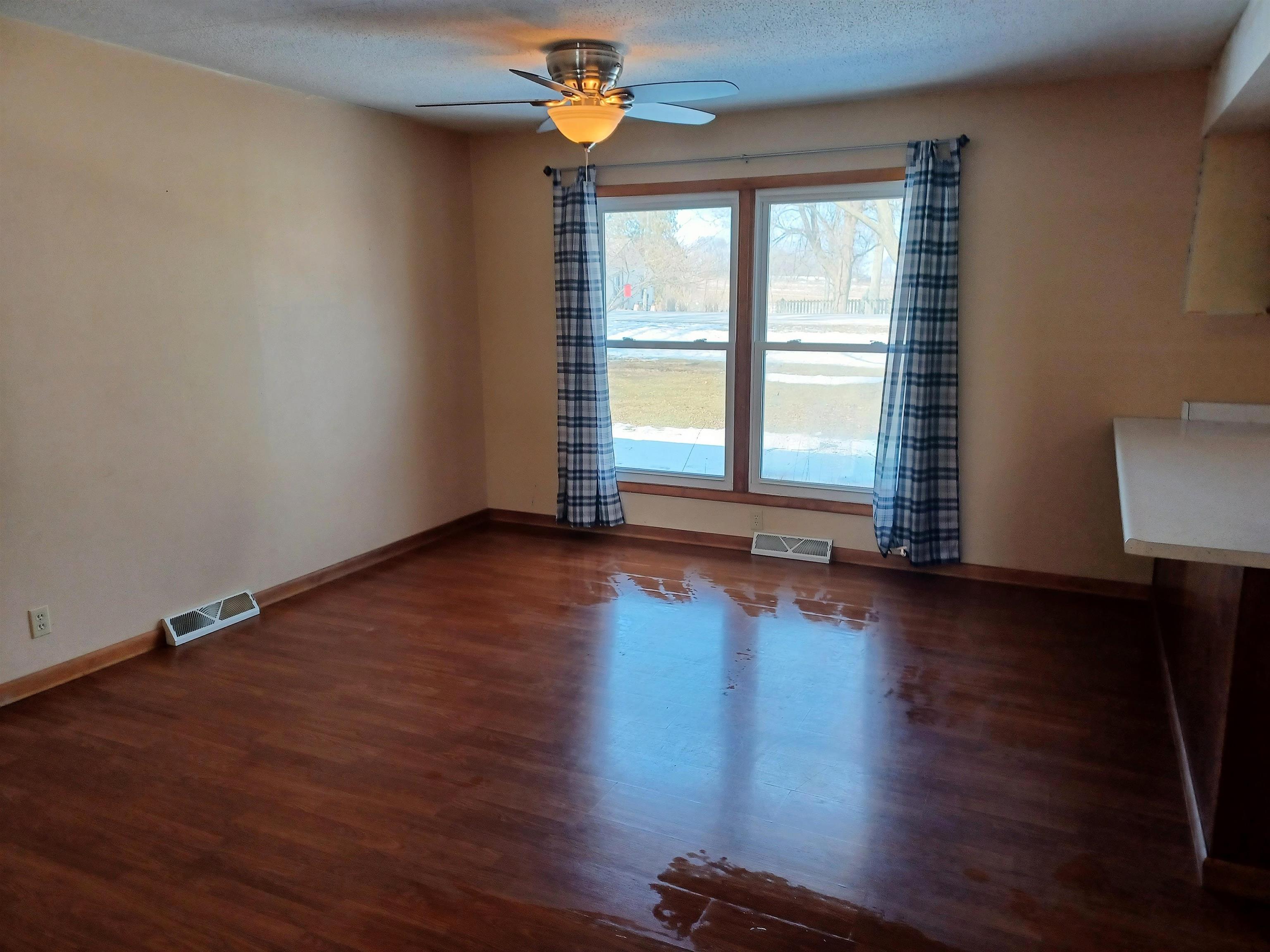 5162 Simpson Road Rockford, IL 61102 - Photo 8 of 14 a view of empty room with wooden floor and fan