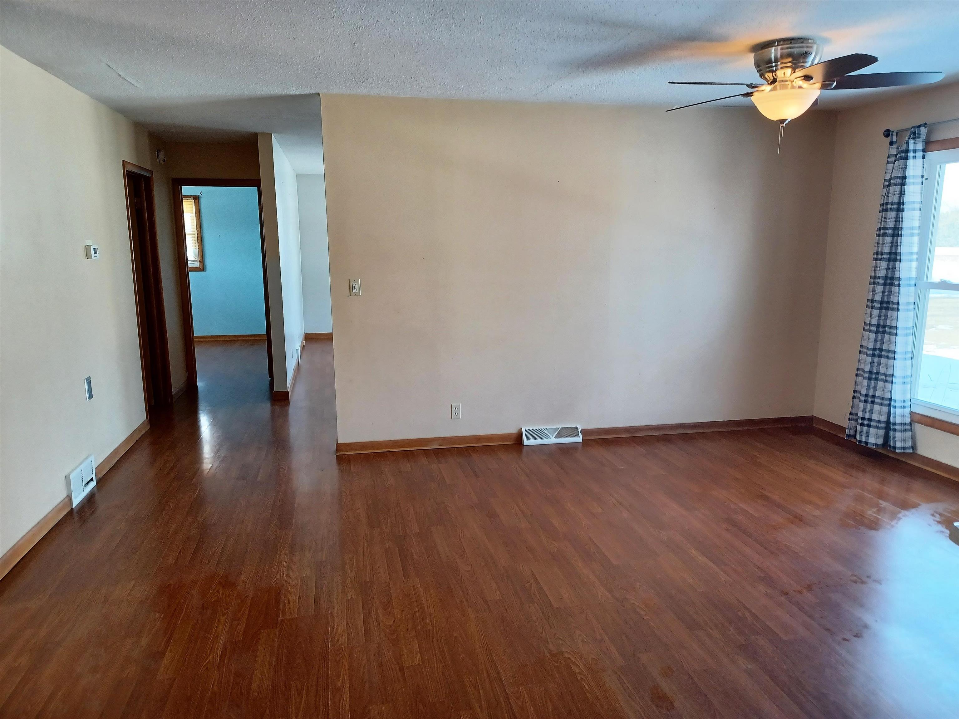 5162 Simpson Road Rockford, IL 61102 - Photo 9 of 14 an empty room with wooden floor and window