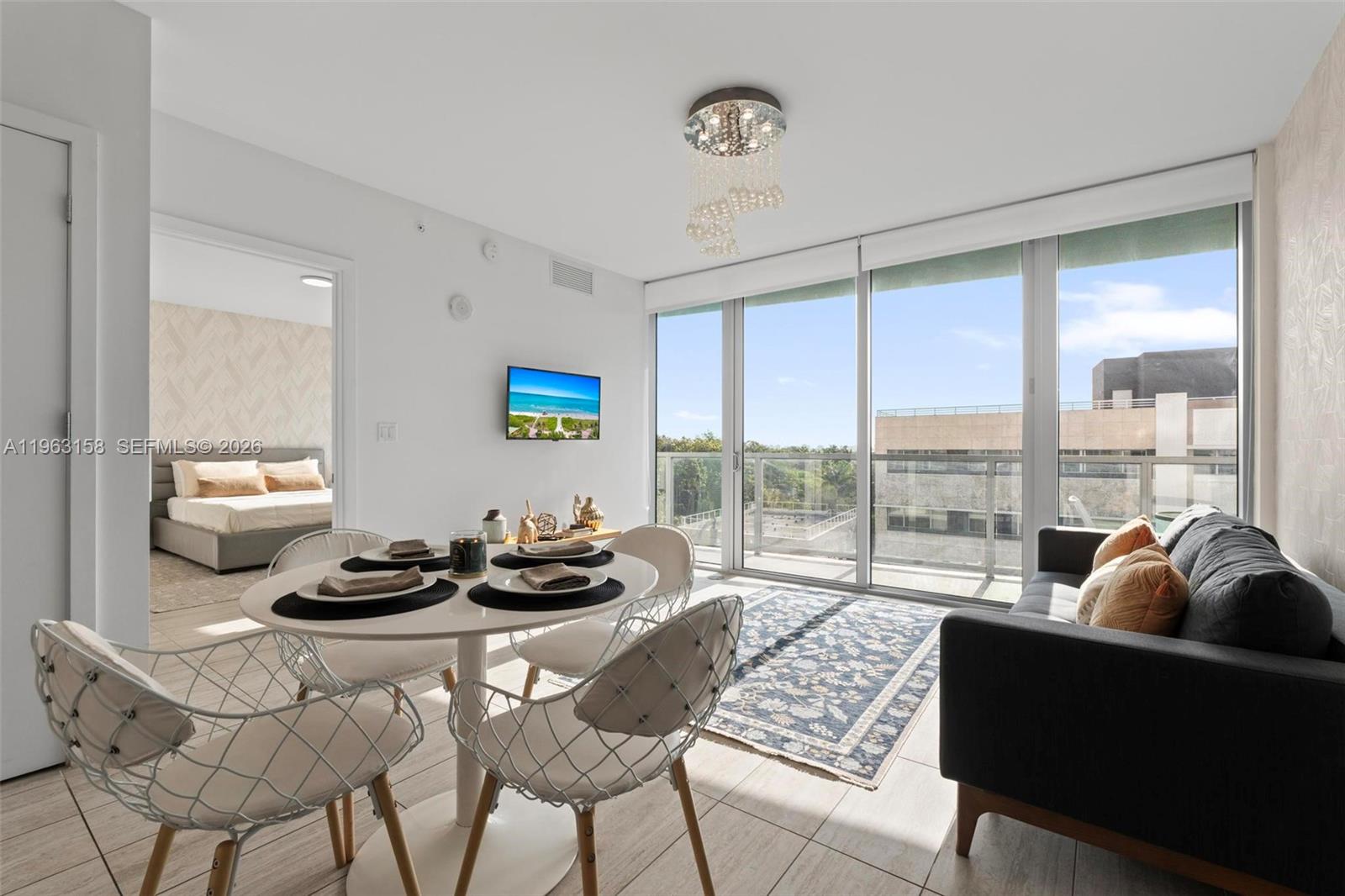 3900 Biscayne Boulevard, Unit S418 Miami, FL 33137 - Photo 22 of 43 a living room with furniture and a floor to ceiling window