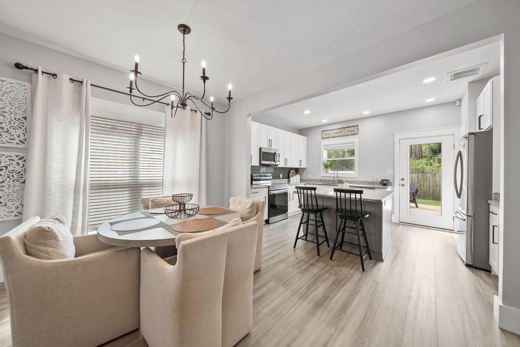 297 Cox Road Santa Rosa Beach, FL 32459 - Photo 12 of 41 a kitchen with a table chairs stove and cabinets