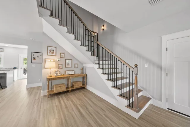 a view of entryway and hall with wooden floor