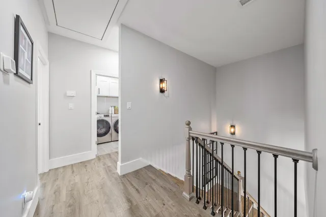 a view of a hallway with wooden floor and closet