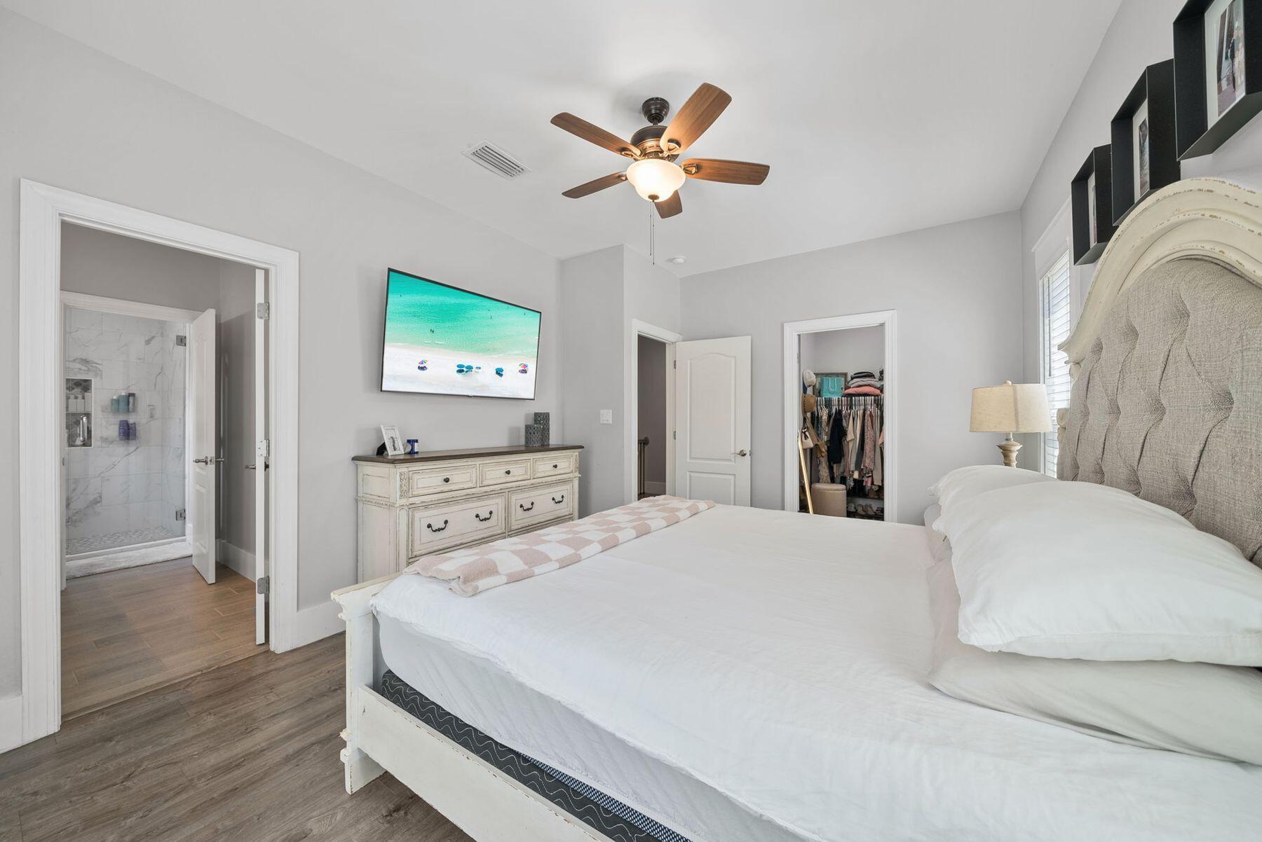 297 Cox Road Santa Rosa Beach, FL 32459 - Photo 20 of 41 a bedroom with a bed and a chandelier