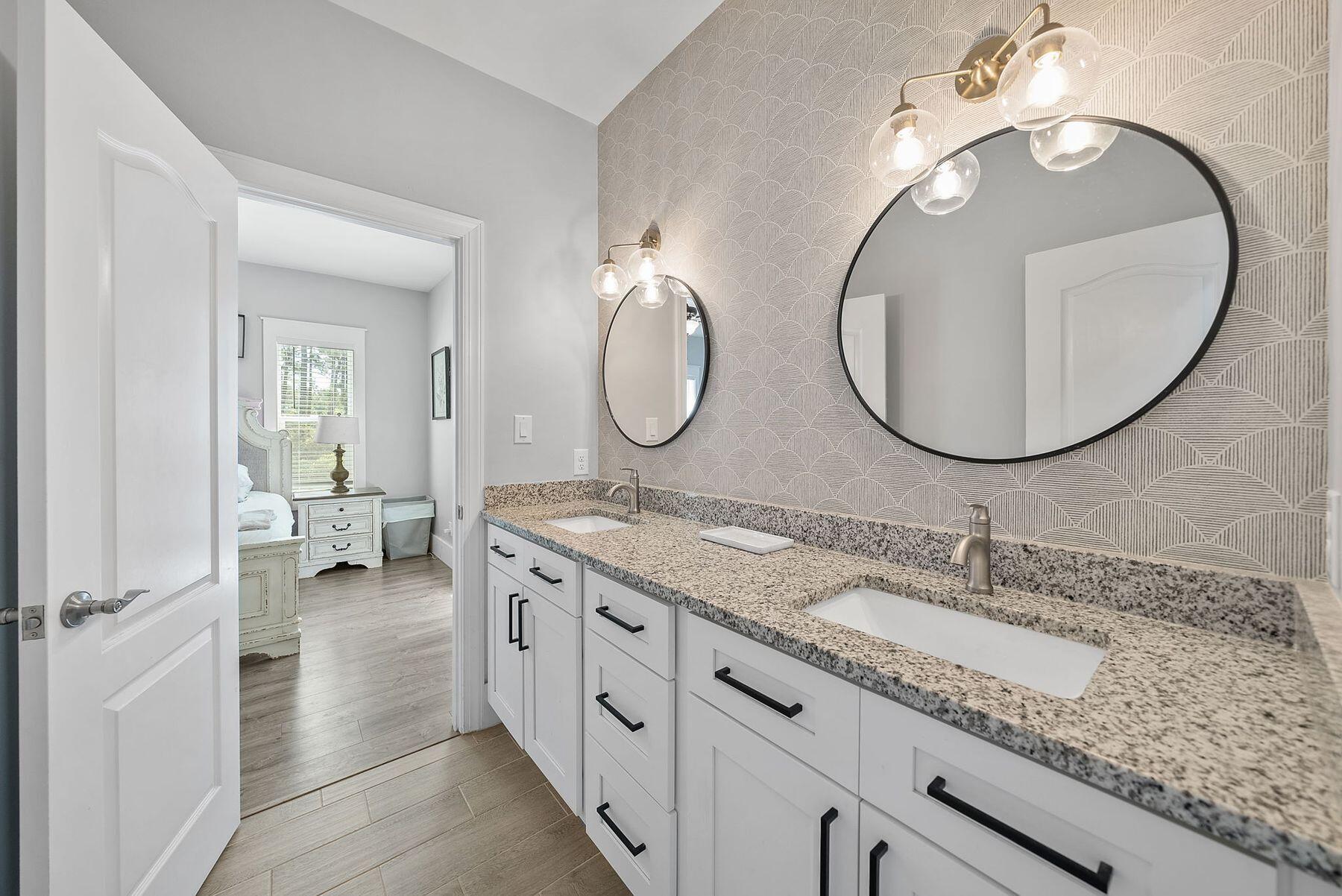 297 Cox Road Santa Rosa Beach, FL 32459 - Photo 21 of 41 a en suite bathroom with a granite countertop double vanity sink and a mirror