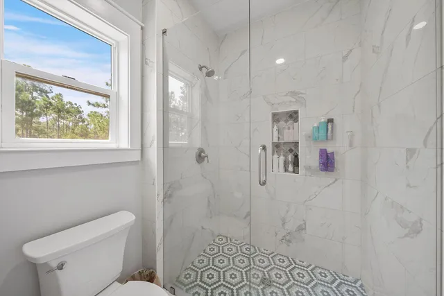 a bathroom with a toilet sink and shower