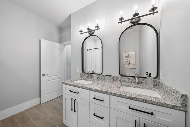 a bathroom with double vanity sinks and a granite counter tops