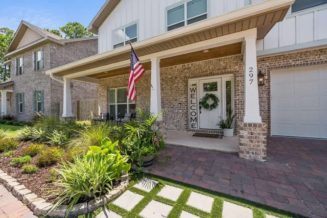 a front view of a house with garden