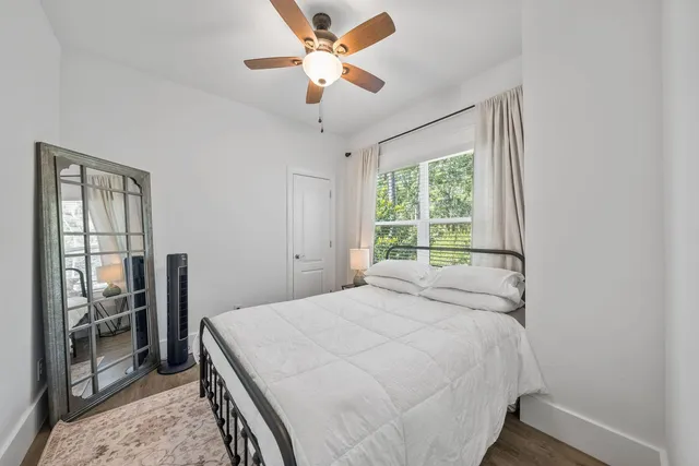a bedroom with a large bed and a chandelier