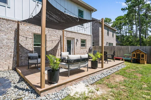 a view of a house with backyard porch and sitting area
