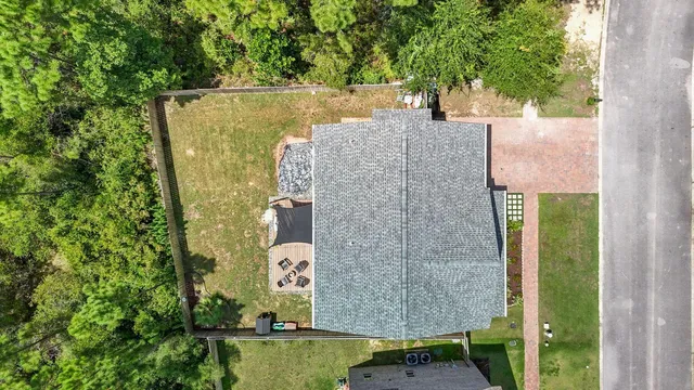 an aerial view of a house with outdoor space and a fountain