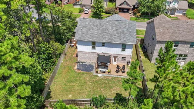 an aerial view of a house with garden space and street view