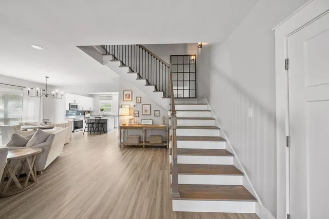 a view of entryway and hall with wooden floor