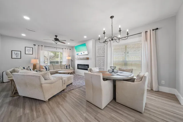 a living room with fireplace furniture and a chandelier