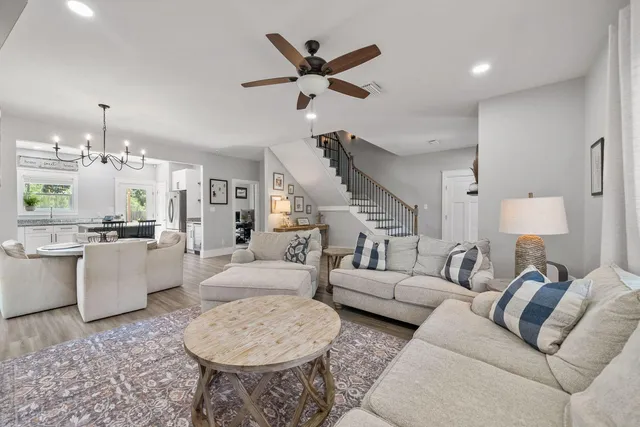 a living room with furniture and kitchen view